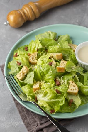 Caesar salad with croutons and bacon.
