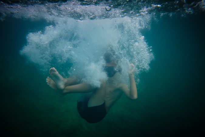 Boy underwater in clear sea