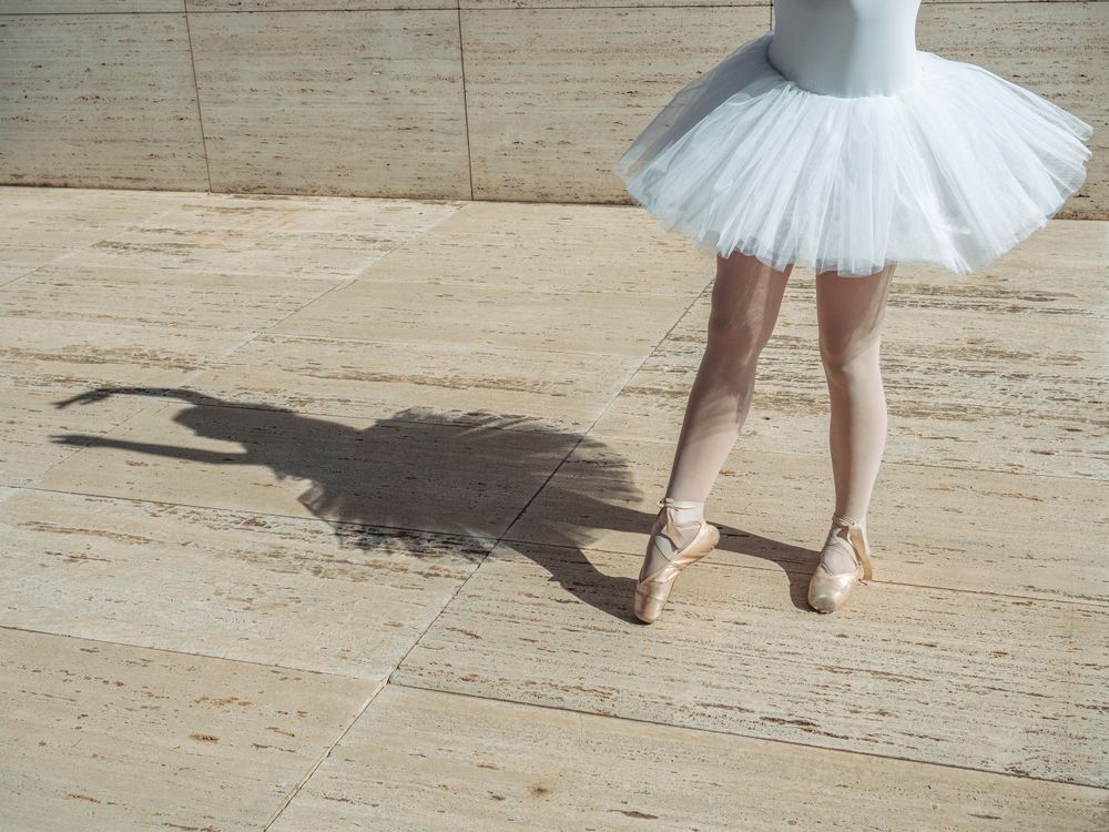 Ballerina standing on tiptoe classical position outside