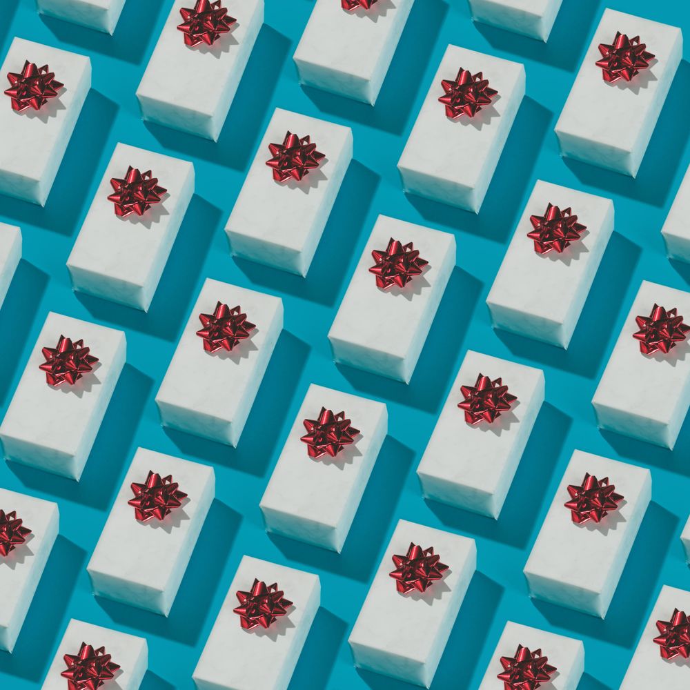 Pattern made of gift boxes on blue background