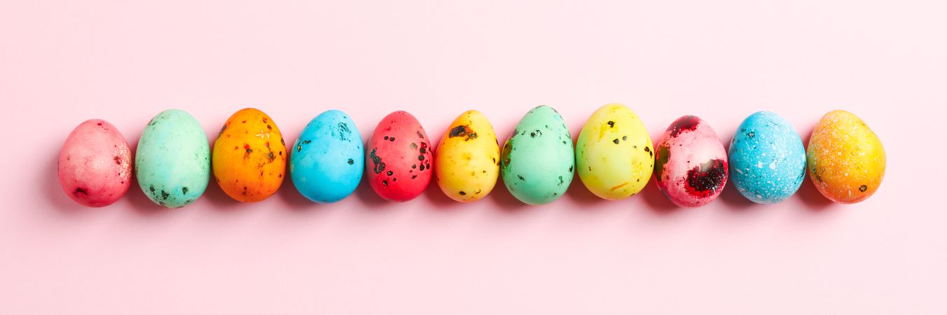 Decorative Easter eggs on color background, space for text. Top view