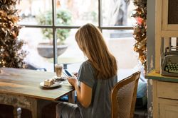 Woman using smartphone in cafe