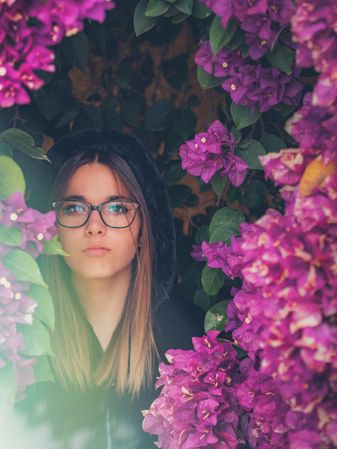 Woman on background of stunning violet flowers