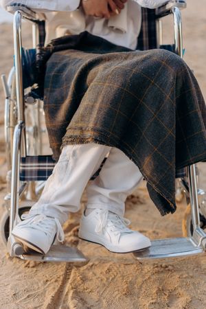 Person sitting on wheelchair in close-up