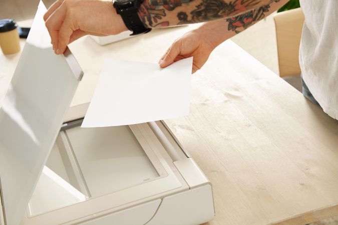 Man putting paper into a printer