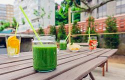 Snacks and fruity drinks on empty table outside