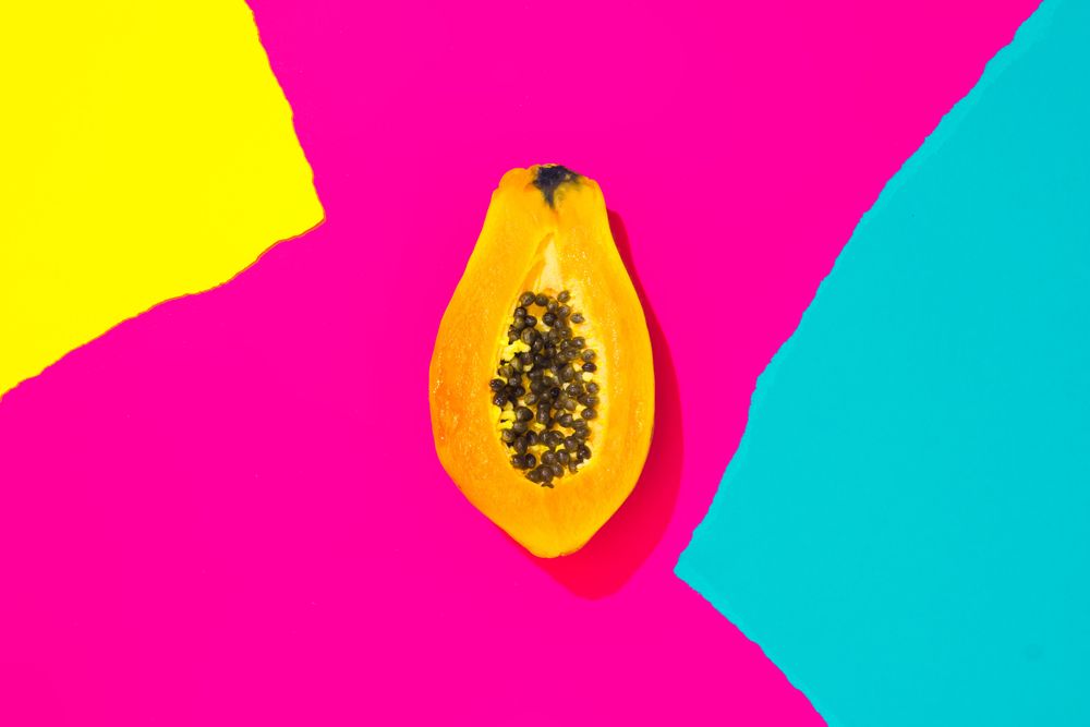 Papaya on pattern of ripped paper in vivid colors
