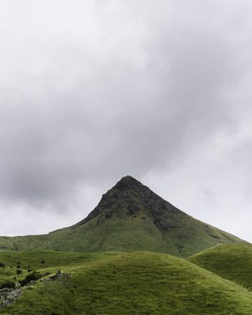 Mountain peak with gloomy clouds above