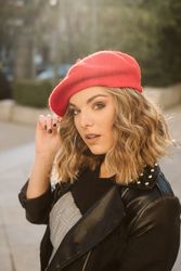 Stylish female in beret looking at camera
