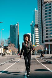 Woman with afro hair walking through the streets
