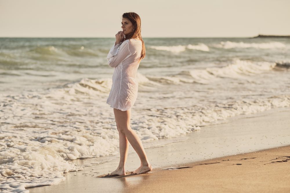 Woman with white dress at the beach