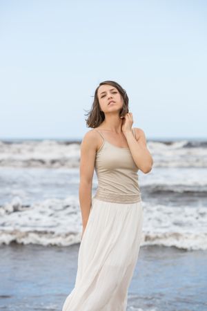 Charming young woman on shore near water