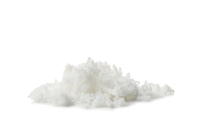 Coconut flakes isolated on light background. Tropical fruit