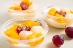 Three bowls of pudding fruit with a flower like shape from grape