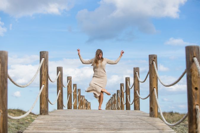 Young woman posing on footbridge