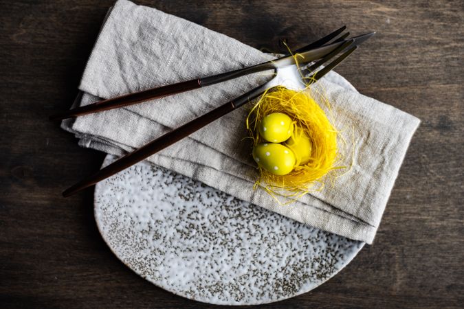 Nest of yellow eggs in nest on an Easter table setting