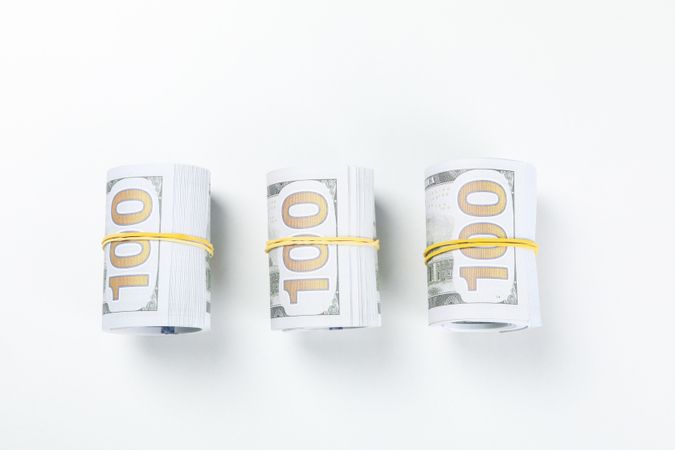 Twisted money with a rubber band, on a light background.