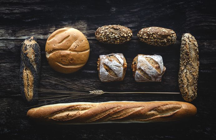 Assorted gold homemade bread on dark wood background