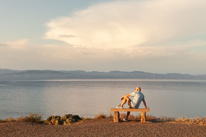 Man sitting on bench and enjoying sea view