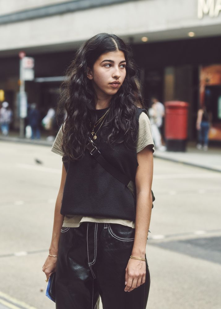 London, England, United Kingdom - September 18 2021: Woman with long hair in vest and jeans