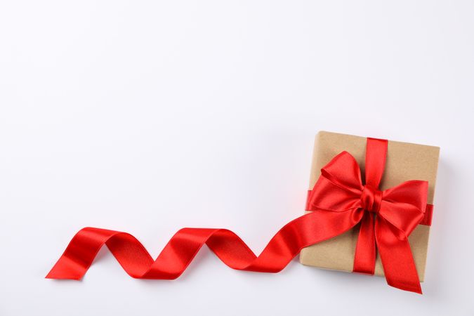 Beautiful gift box with red bow on blank background, space for text