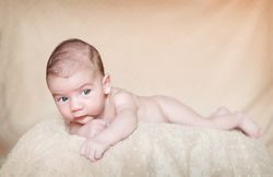 Portrait of newborn baby lying down over a blanket