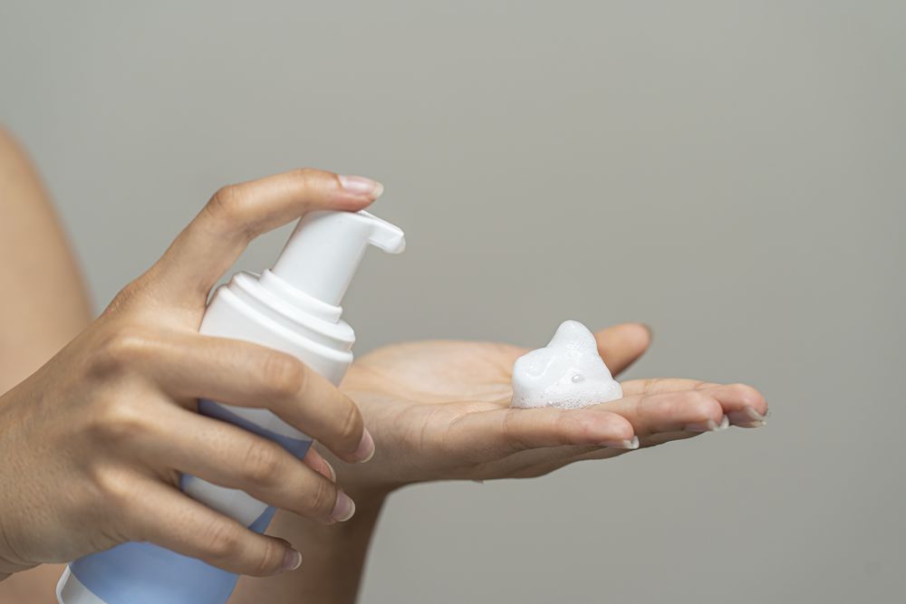 Foaming cleanser skincare product from soap dispenser pump bottle; hand wash in beauty routine.