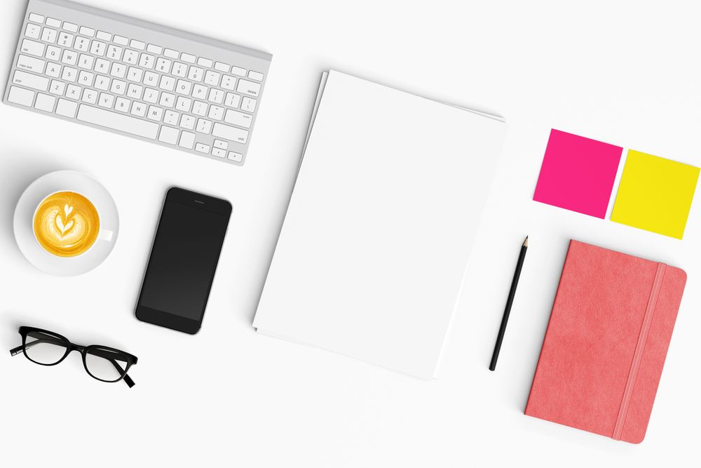 Modern workspace with coffee cup, smartphone, paper, tablet and notebook copy space