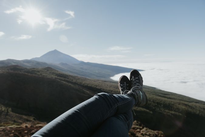 Tourist resting on top of hill