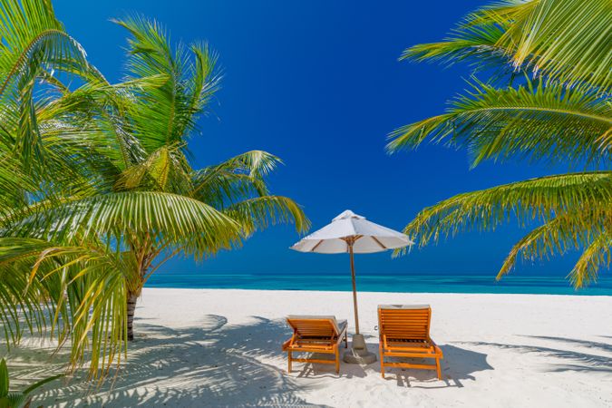 Reclining lounge chairs on a tropical beach in the Maldives