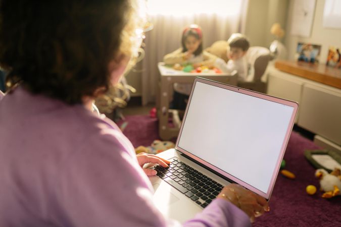 Woman in pink shirt using MacBook pro