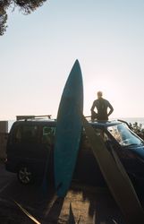 Man enjoying the sunrise in his camped van