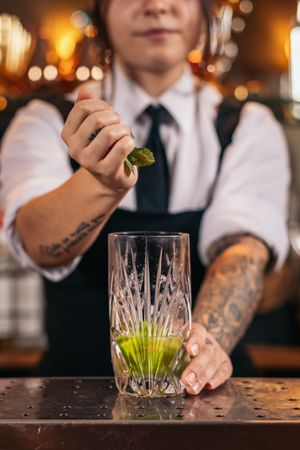 Bartender preparing a mojito in a cocktail bar