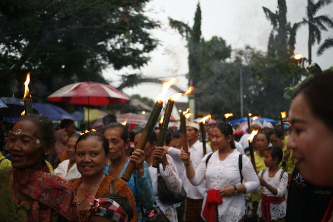 Group of women with torches marches during Nyepi day