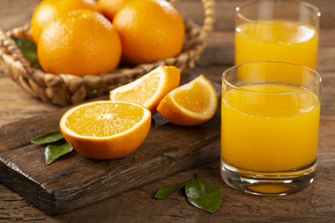 Glass with orange juice on the table.
