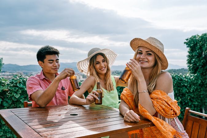 a group of young people having a good time in a summer day and cheering with beer