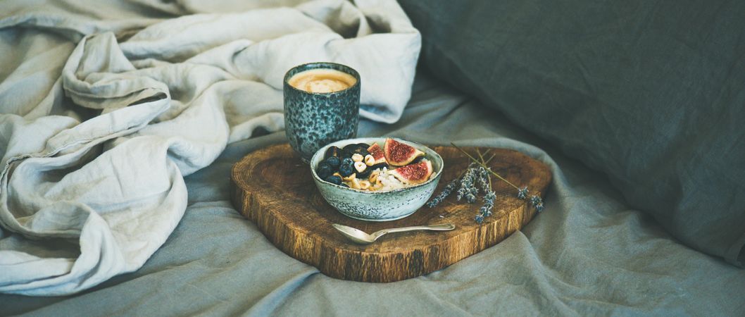Warm healthy breakfast with coffee in bed