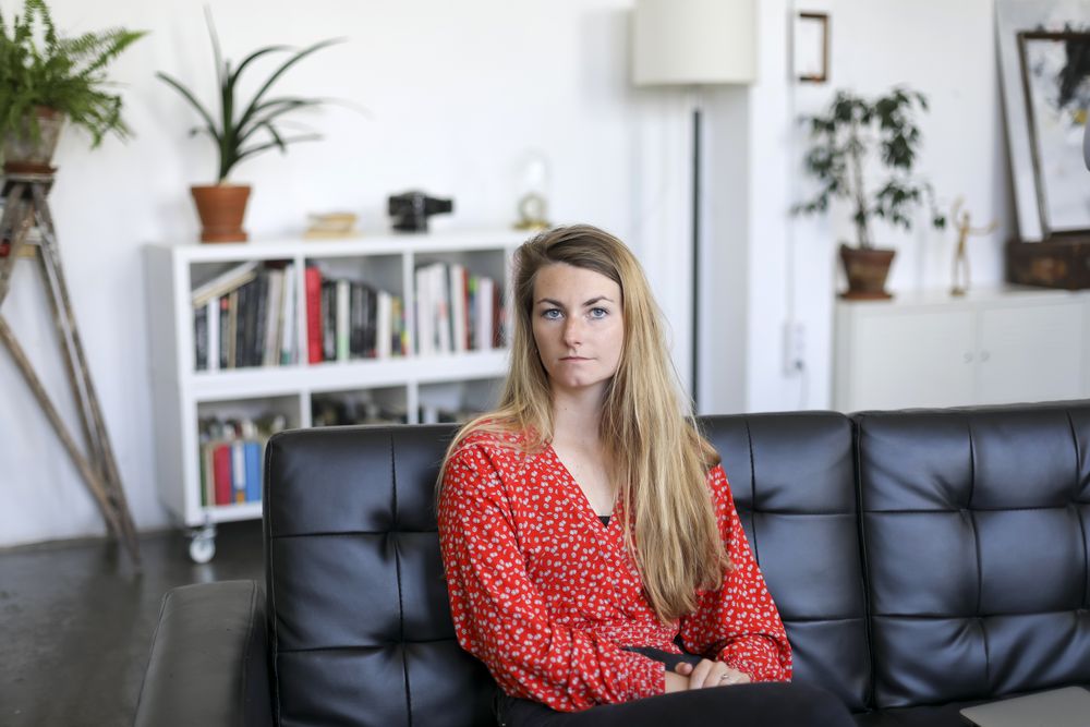 Pensive woman sitting on sofa at home