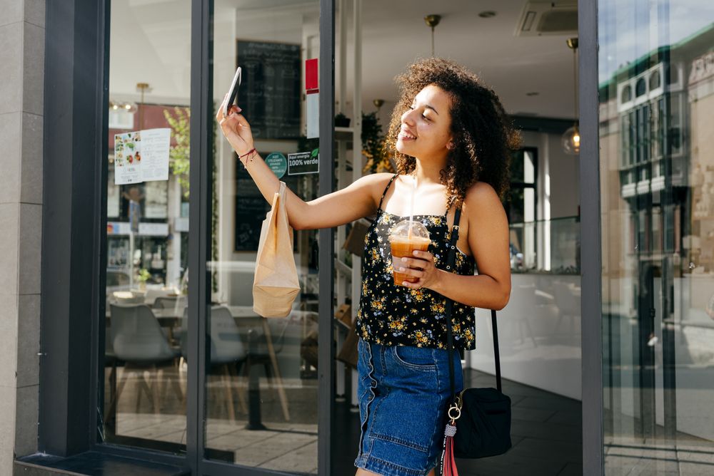 Cheerful Latina woman leaving restaurant