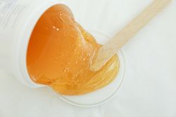 Liquid yellow paste for sugaring on blank background