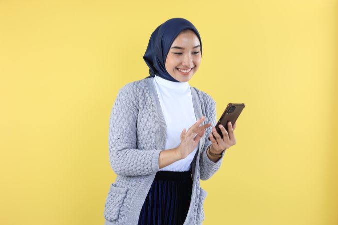 Indonesian Asian Hijab Woman Excited Holding Smart Phone