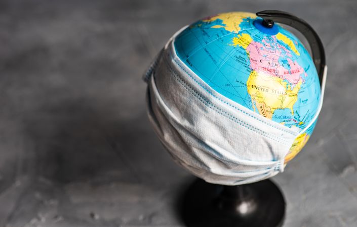 Globe covered in facemask