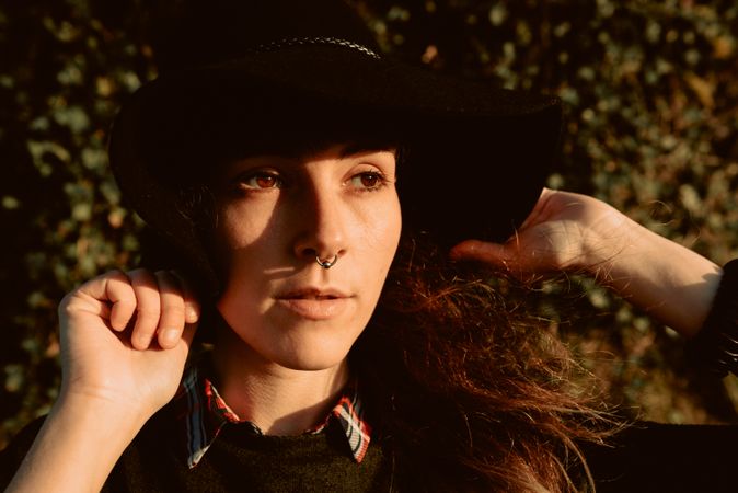 Stylish young woman in felt hat outdoors