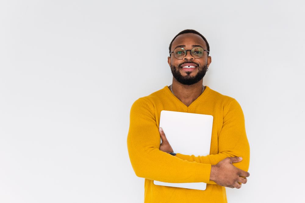 Smiling Black man with laptop