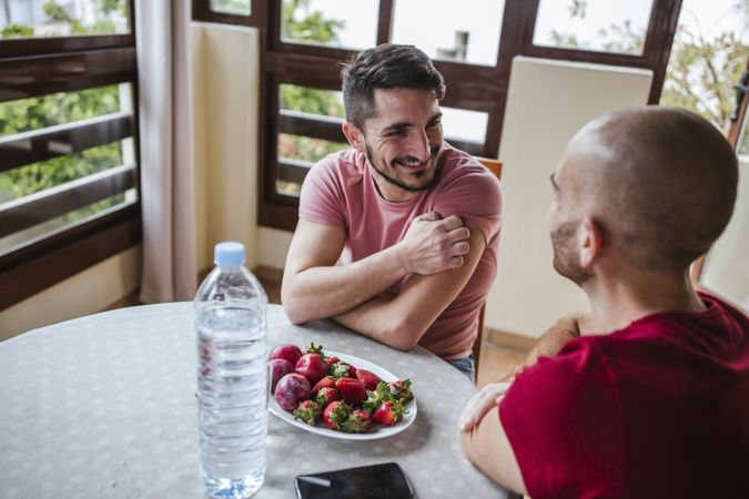 Gay couple eating strawberries