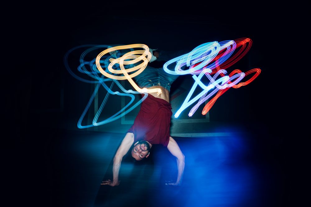bearded man dancing in spotlight