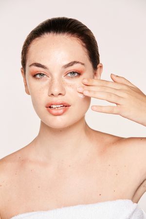 Amiable female taking care of face