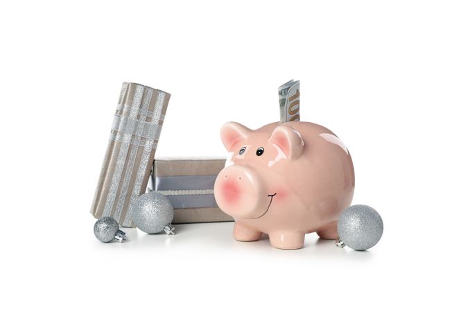 Concept of Christmas finance with piggy bank, isolated on light background