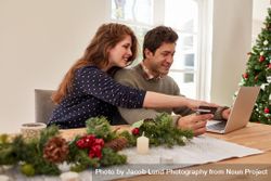 Couple doing online shopping for christmas 0KMVQA