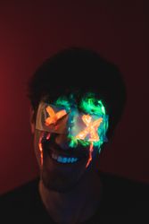 Male with covered eyes and neon face